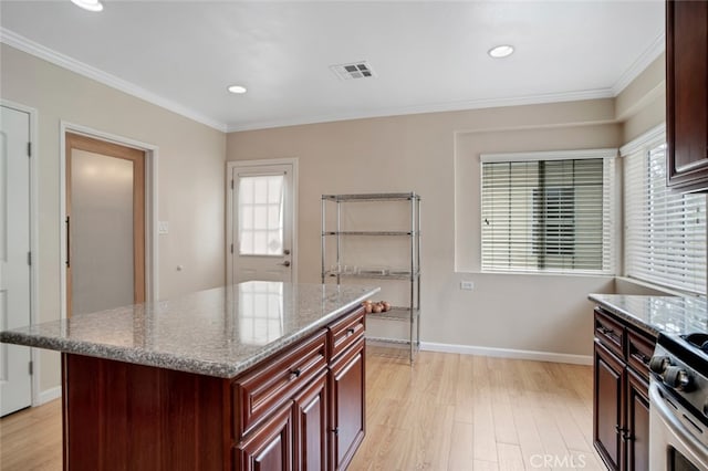 17450 Devonshire St, Northridge, CA 91325 - kitchen with light wood-style flooring, healthy amount of natural light, crown molding, reddish brown cabinets, and recessed lighting