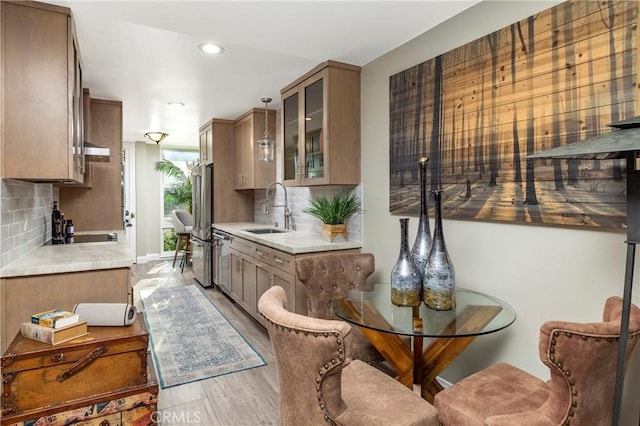 16520 Harbour Ln Unit 6, Huntington Beach, CA 92649 - kitchen with light countertops, stainless steel appliances, glass insert cabinets, tasteful backsplash, and recessed lighting