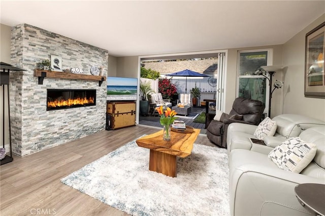 16520 Harbour Ln Unit 6, Huntington Beach, CA 92649 - living room featuring a fireplace and wood finished floors