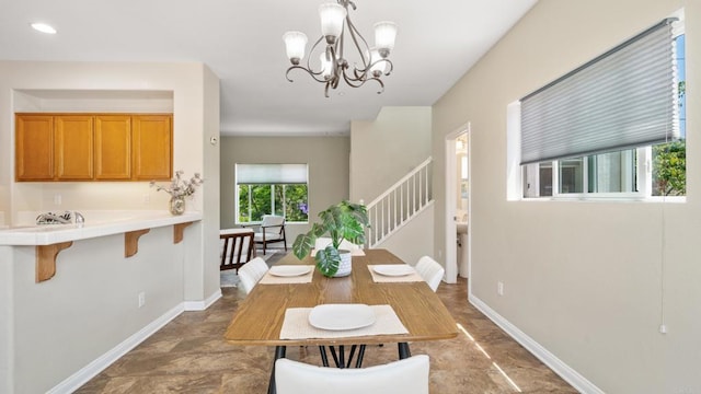 534 64th St, San Diego, CA 92114 - dining space featuring stone finish flooring, a chandelier, and stairway