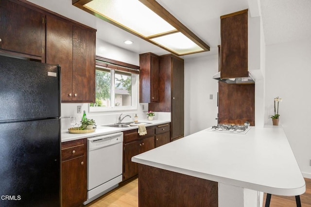 2247 Camilar Dr, Camarillo, CA 93010 - kitchen with white appliances, a peninsula, light countertops, light wood finished floors, and dark brown cabinets