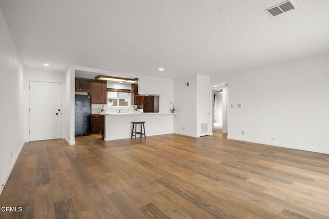 2247 Camilar Dr, Camarillo, CA 93010 - unfurnished living room featuring a textured ceiling, dark wood-type flooring, and recessed lighting