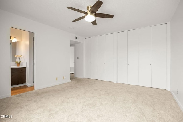 2247 Camilar Dr, Camarillo, CA 93010 - unfurnished bedroom featuring carpet, multiple closets, connected bathroom, and ceiling fan