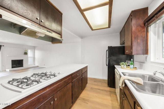 2247 Camilar Dr, Camarillo, CA 93010 - kitchen featuring light countertops, light wood-type flooring, under cabinet range hood, white appliances, and open floor plan