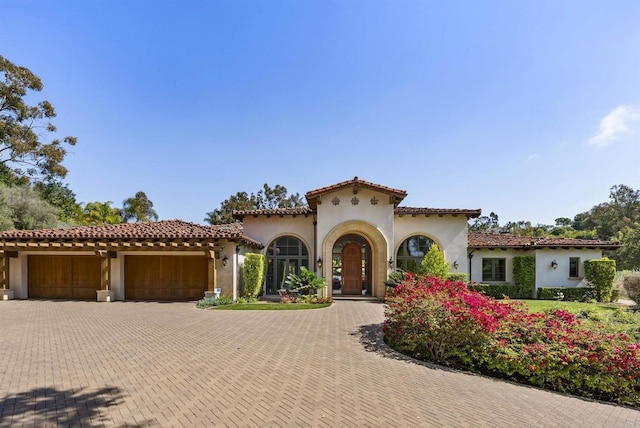 17324 Calle Serena, Rancho Santa Fe, CA 92067 - mediterranean / spanish home featuring stucco siding, a garage, decorative driveway, and a tiled roof