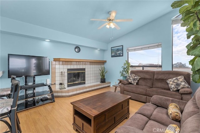 1358 Clarabelle Dr, Morro Bay, CA 93442 - living room with a ceiling fan, vaulted ceiling, wood finished floors, and a tiled fireplace
