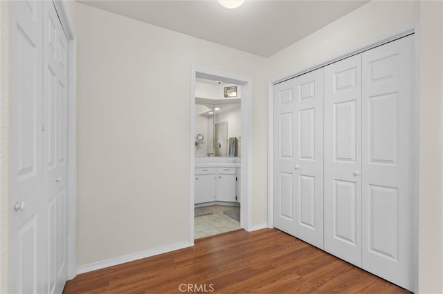 1358 Clarabelle Dr, Morro Bay, CA 93442 - unfurnished bedroom featuring wood finished floors, a closet, and connected bathroom
