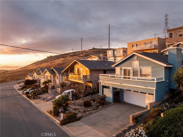 1358 Clarabelle Dr, Morro Bay, CA 93442 - view of front of house with a balcony, driveway, a garage, and a mountain view