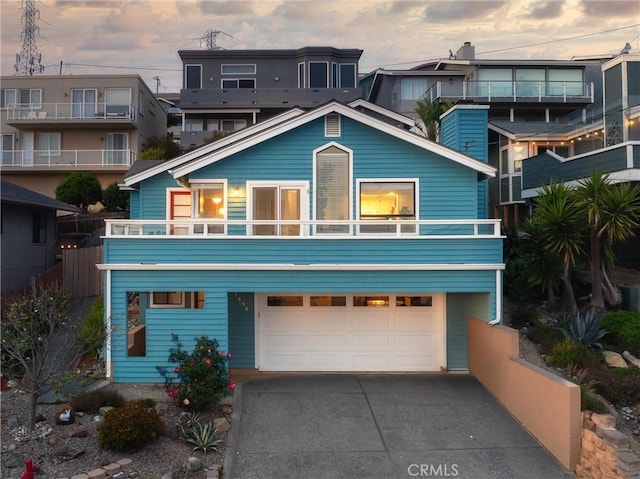 1358 Clarabelle Dr, Morro Bay, CA 93442 - view of front facade featuring an attached garage, concrete driveway, and a balcony