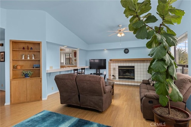 1358 Clarabelle Dr, Morro Bay, CA 93442 - living area featuring wood finished floors, ceiling fan, a fireplace, and high vaulted ceiling