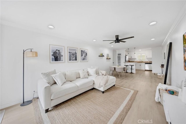 1055 Orizaba Ave Unit 3, Long Beach, CA 90804 - living area with light wood-style flooring, recessed lighting, ornamental molding, and a ceiling fan