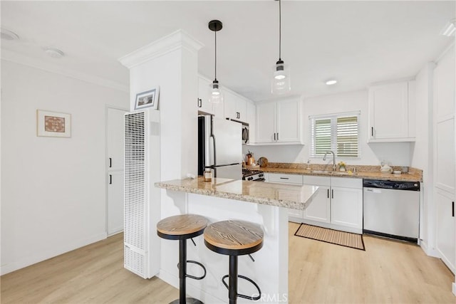 1055 Orizaba Ave Unit 3, Long Beach, CA 90804 - kitchen featuring stainless steel appliances, a heating unit, light wood-type flooring, a kitchen breakfast bar, and white cabinetry