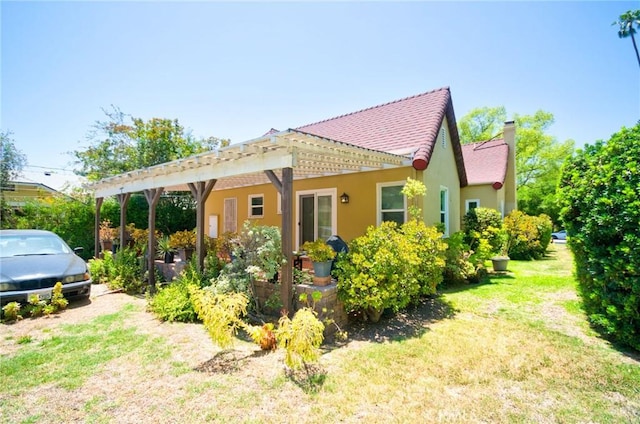 900 S Los Robles Ave, Pasadena, CA 91106 - back of property with stucco siding, a chimney, a lawn, and a pergola