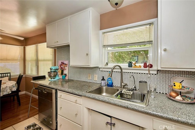 900 S Los Robles Ave, Pasadena, CA 91106 - kitchen featuring stainless steel dishwasher, backsplash, white cabinetry, and light countertops