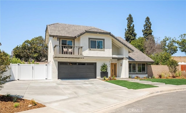 21679 Calle Alcazar, Yorba Linda, CA 92887 - view of front of home featuring a gate, concrete driveway, a balcony, a garage, and stucco siding