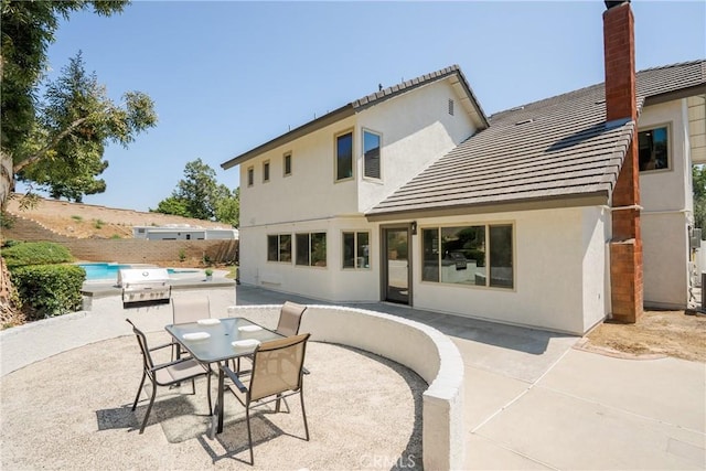 21679 Calle Alcazar, Yorba Linda, CA 92887 - rear view of property featuring a tile roof, stucco siding, a patio area, and a chimney