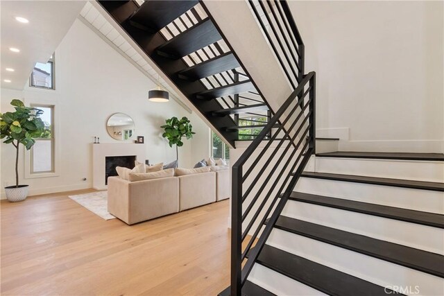 21679 Calle Alcazar, Yorba Linda, CA 92887 - stairway featuring wood finished floors, a fireplace, and recessed lighting
