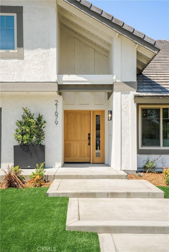 21679 Calle Alcazar, Yorba Linda, CA 92887 - doorway to property featuring stucco siding and a yard