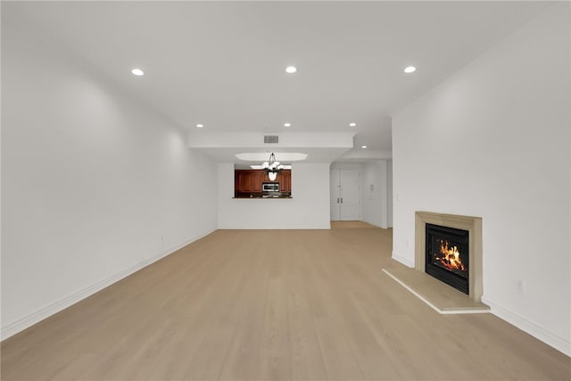 8555 Cashio St Unit 203, Los Angeles, CA 90035 - unfurnished living room featuring recessed lighting, light wood-style flooring, and a glass covered fireplace