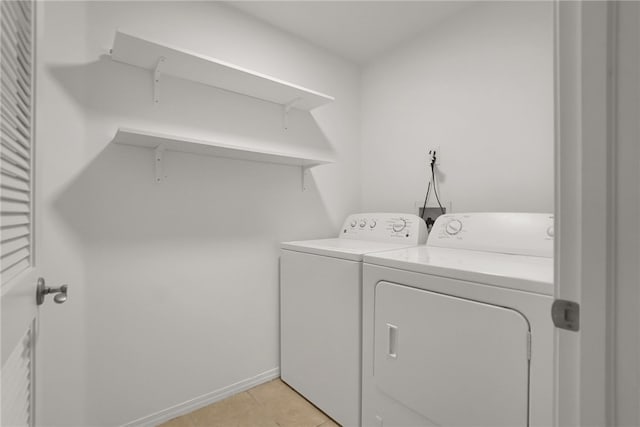 8555 Cashio St Unit 203, Los Angeles, CA 90035 - laundry area featuring washing machine and clothes dryer and light tile patterned floors