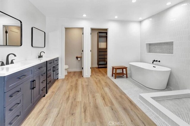 1500 Pacific Ave, Norco, CA 92860 - full bathroom with double vanity, wood finished floors, a freestanding tub, and recessed lighting