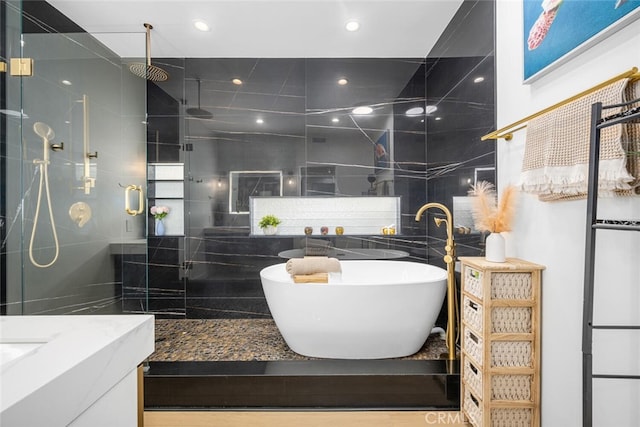 1520 Camden Ave Unit 101, Los Angeles, CA 90025 - bathroom featuring a stall shower, vanity, a freestanding tub, and tile walls