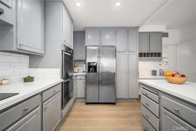 1520 Camden Ave Unit 101, Los Angeles, CA 90025 - kitchen featuring appliances with stainless steel finishes, gray cabinets, recessed lighting, light countertops, and backsplash