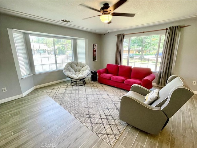 3332 Shamrock Pl, Merced, CA 95340 - living area featuring plenty of natural light, wood finished floors, a ceiling fan, and a textured ceiling