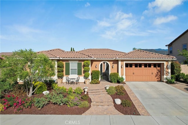 44655 Howell Mountain St, Temecula, CA 92592 - mediterranean / spanish-style home featuring an attached garage, concrete driveway, a tiled roof, and stucco siding