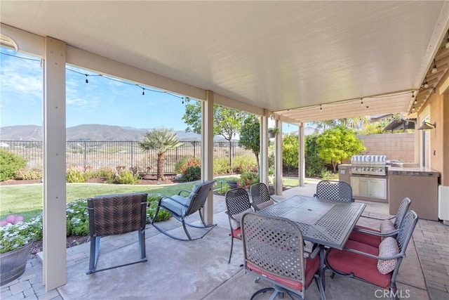 44655 Howell Mountain St, Temecula, CA 92592 - fenced backyard featuring a mountain view, a patio area, exterior kitchen, and outdoor dining space