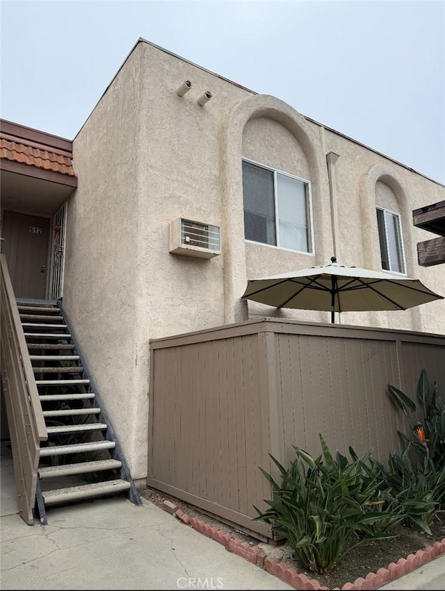 212 S Kraemer Blvd, Placentia, CA 92870 - view of home's exterior with stucco siding, stairs, and a wall unit AC