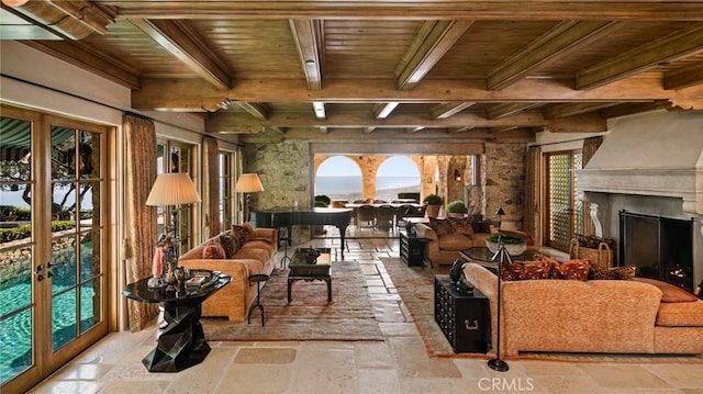 36 Pelican Crest Dr, Newport Coast, CA 92657 - living room featuring stone tile flooring, a wooden ceiling with exposed beams, french doors, and a fireplace