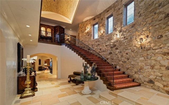 36 Pelican Crest Dr, Newport Coast, CA 92657 - entryway featuring arched walkways, a high ceiling, stairs, recessed lighting, and stone tile floors