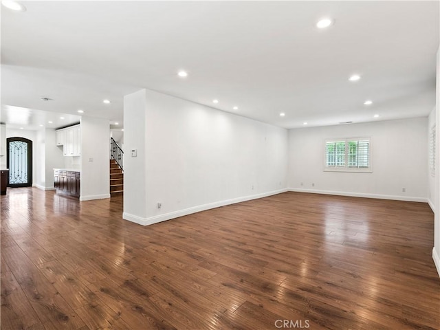 2128 E 3rd St, Los Angeles, CA 90033 - empty room featuring stairs, dark wood-style flooring, recessed lighting, and arched walkways