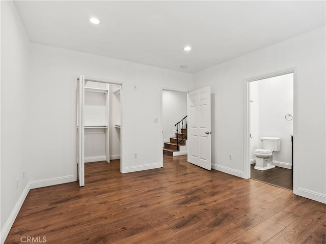 2128 E 3rd St, Los Angeles, CA 90033 - unfurnished bedroom with a walk in closet, wood finished floors, recessed lighting, ensuite bath, and a closet