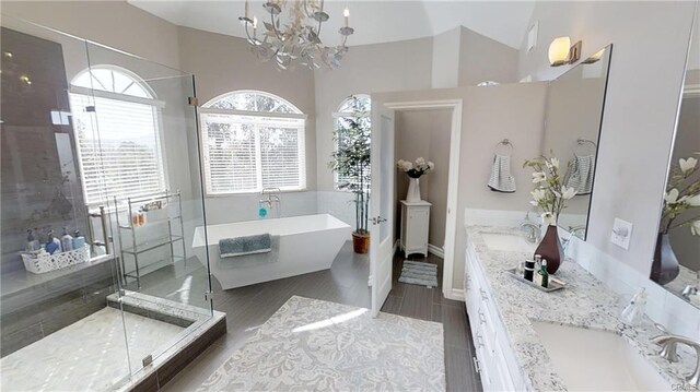 30967 Steeplechase Dr, San Juan Capistrano, CA 92675 - bathroom with a freestanding bath, double vanity, a chandelier, a shower stall, and lofted ceiling