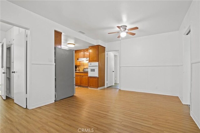 3857 W 135th, Hawthorne, CA 90250 - unfurnished living room featuring a ceiling fan and light wood-type flooring