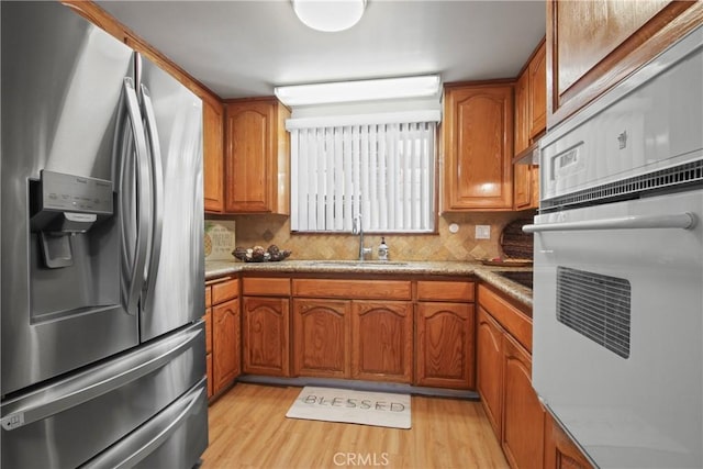 3857 W 135th, Hawthorne, CA 90250 - kitchen with stainless steel fridge with ice dispenser, white oven, and brown cabinetry