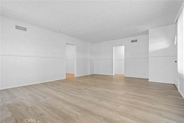3857 W 135th, Hawthorne, CA 90250 - unfurnished room with light wood-style flooring and a wainscoted wall