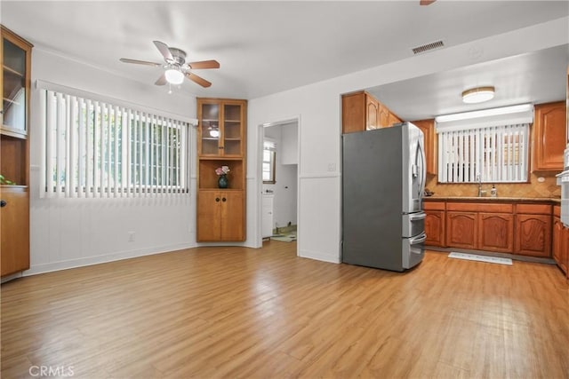 3857 W 135th, Hawthorne, CA 90250 - kitchen with stainless steel fridge, ceiling fan, light wood-style flooring, and brown cabinetry