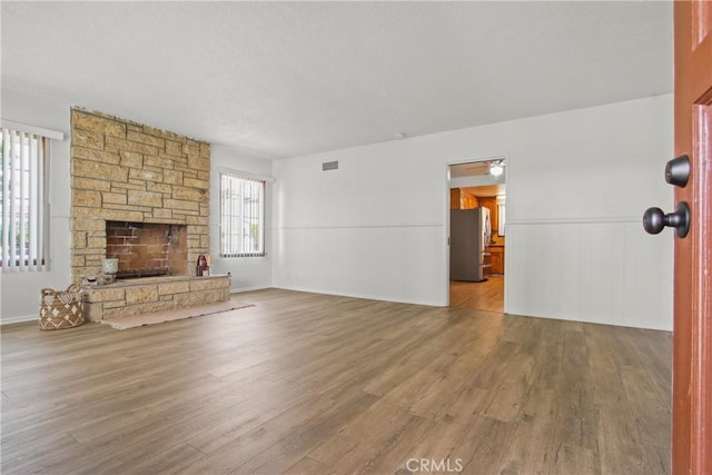 3857 W 135th, Hawthorne, CA 90250 - unfurnished living room featuring wood finished floors, a fireplace, and wainscoting