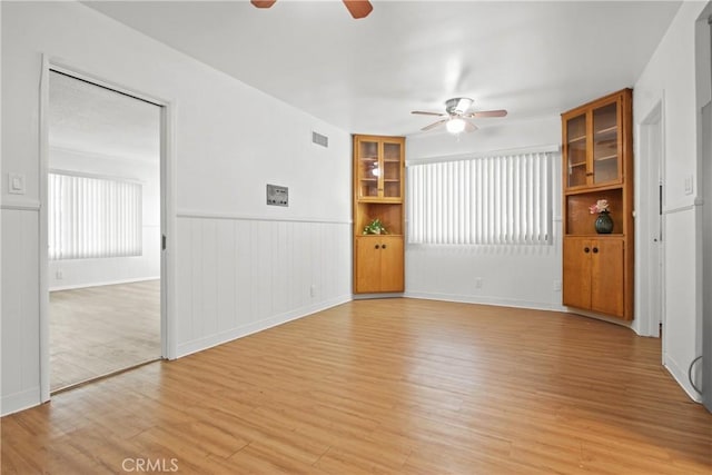 3857 W 135th, Hawthorne, CA 90250 - unfurnished room featuring ceiling fan, light wood-style floors, and a wainscoted wall