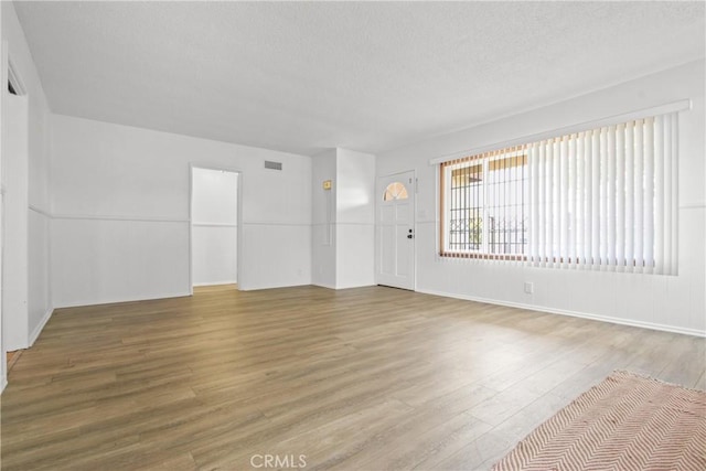 3857 W 135th, Hawthorne, CA 90250 - unfurnished living room featuring wood finished floors and a textured ceiling