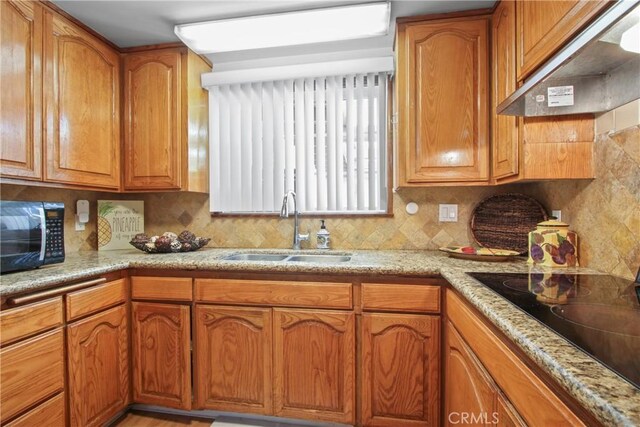 3857 W 135th, Hawthorne, CA 90250 - kitchen featuring black appliances, range hood, backsplash, and brown cabinetry