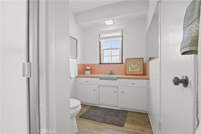 3857 W 135th, Hawthorne, CA 90250 - bathroom with vanity, wood finished floors, decorative backsplash, and a shower