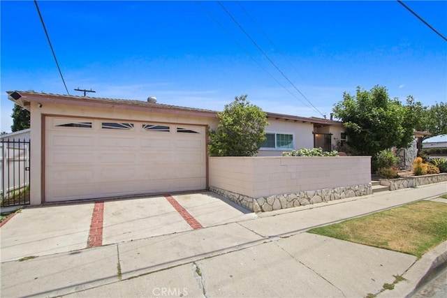 3857 W 135th, Hawthorne, CA 90250 - view of front facade with stucco siding and a garage