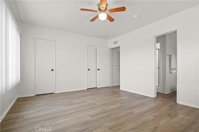 3857 W 135th, Hawthorne, CA 90250 - unfurnished bedroom featuring light wood-type flooring, two closets, ensuite bath, and ceiling fan