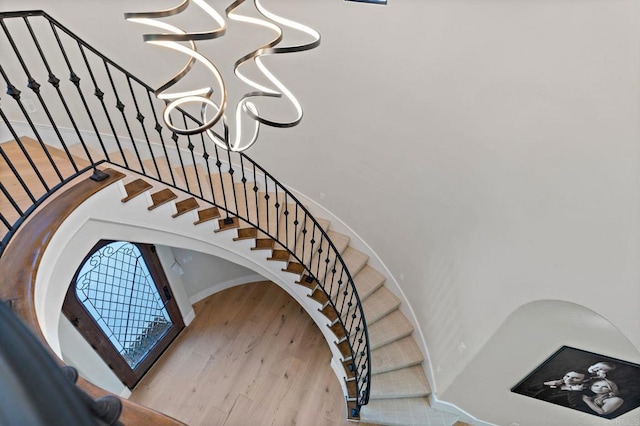 6937 Corte Spagna, Rancho Santa Fe, CA 92091 - staircase with a chandelier, wood finished floors, and a high ceiling