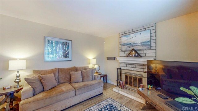 1110 Benjamin Pl, El Cajon, CA 92020 - living area featuring wood finished floors and a brick fireplace