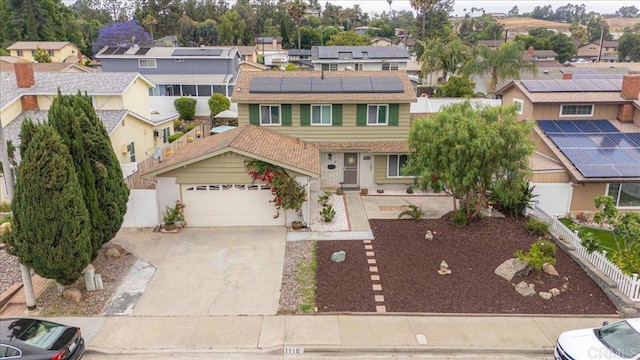1110 Benjamin Pl, El Cajon, CA 92020 - view of front of home featuring a garage, a residential view, concrete driveway, and roof mounted solar panels
